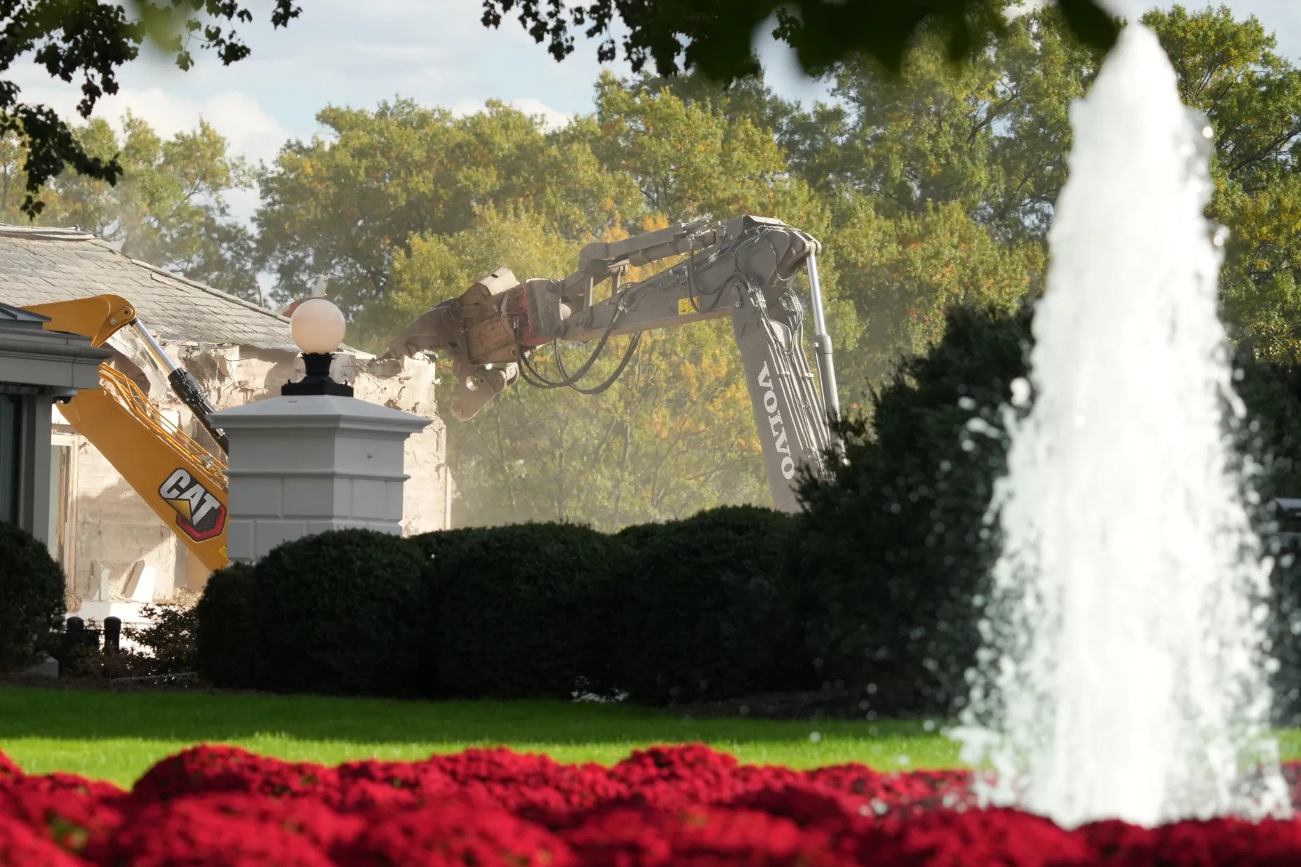 Construction workers on the U.S. Treasury roof watch the largely demolished East Wing of the White House on October 23, 2025