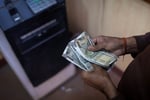 Indian rupee currency traders monitor screens as Iran strikes rattle bond markets June 2026