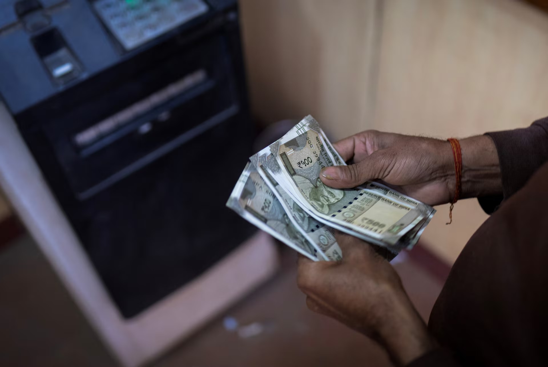 Indian rupee currency traders monitor screens as Iran strikes rattle bond markets June 2026