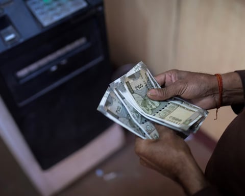 Indian rupee currency traders monitor screens as Iran strikes rattle bond markets June 2026