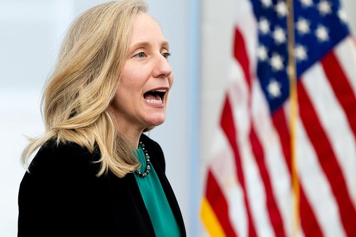 Virginia Governor Abigail Spanberger stands in front of an American flag