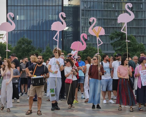 Protesters in Tirana hold pink flamingo cutouts against a Kushner-linked coastal resort in Albania