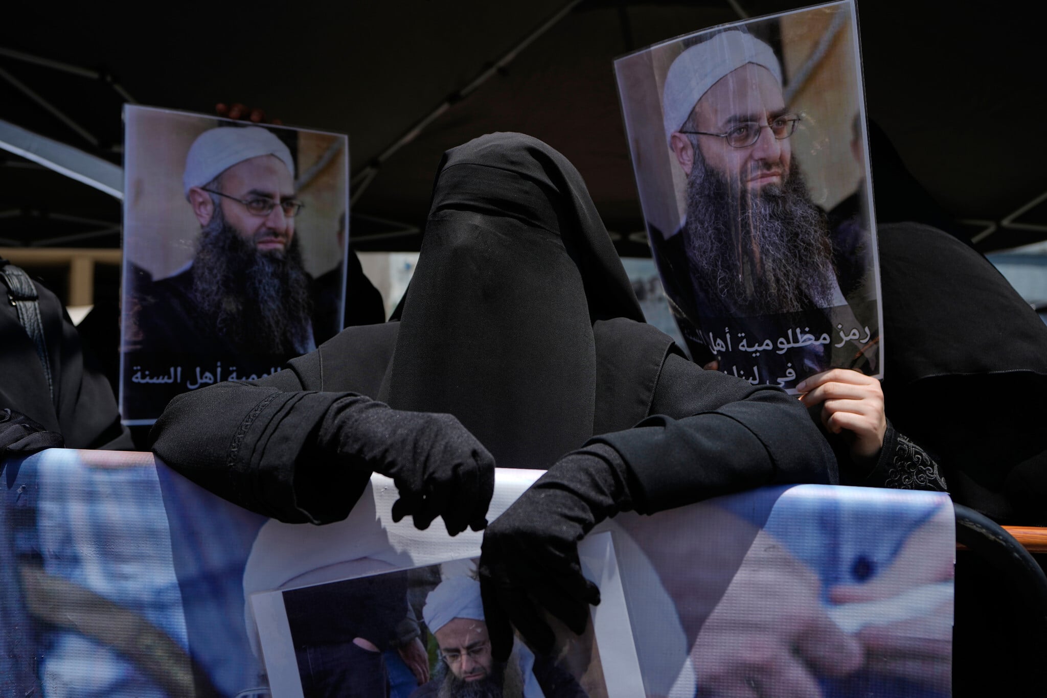 Amal Shamseddine holds portrait of husband Ahmad al-Assir at protest against Lebanon amnesty law Beirut May 2026