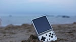 Anbernic RG Rotate handheld gaming device photographed on a surface, as company launches replacement parts store covering 38 models