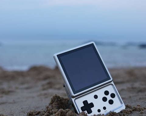 Anbernic RG Rotate handheld gaming device photographed on a surface, as company launches replacement parts store covering 38 models