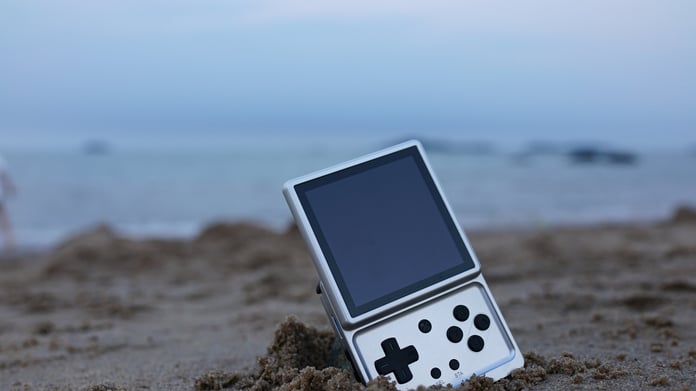 Anbernic RG Rotate handheld gaming device photographed on a surface, as company launches replacement parts store covering 38 models