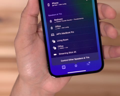Apple AirPlay icon on iPhone screen with Roku Streaming Stick showing iOS casting interface