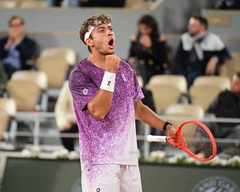 Flavio Cobolli in action against Felix Auger-Aliassime at Roland Garros 2026