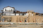 Contractors build a new home at Taylor Morrison La Solara community in Dublin California