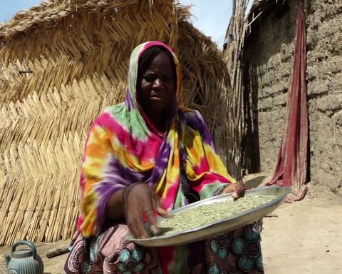 A displaced woman stands in a deteriorating camp in Maiduguri, Borno state