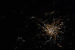 NASA astronaut photograph from ISS of Budapest Hungary at night showing Danube River dividing Buda Pest Obuda