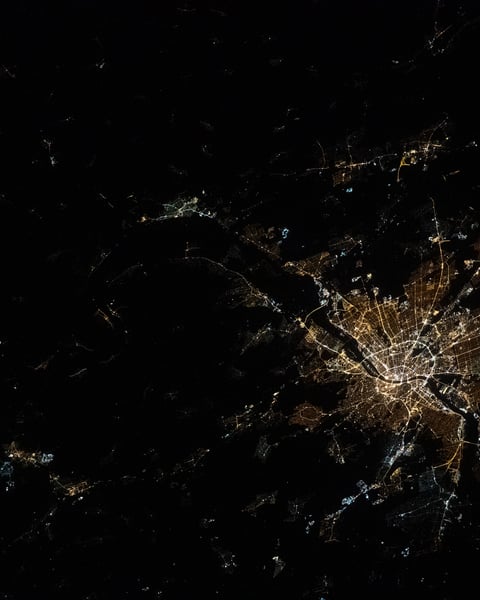 NASA astronaut photograph from ISS of Budapest Hungary at night showing Danube River dividing Buda Pest Obuda