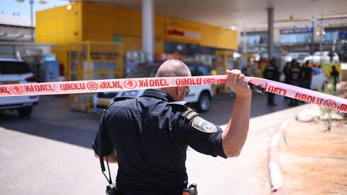 Security forces at the scene of the central Israel shooting attack near Kochav Yair