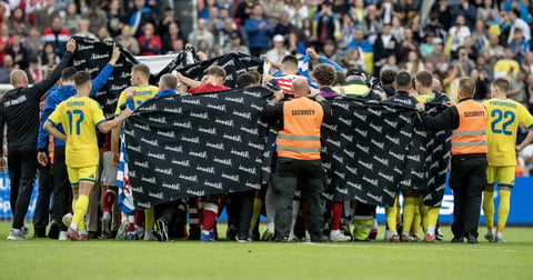 Denmark and Ukraine players surrounding Christian Eriksen after he collapsed at Nature Energy Park Odense June 2026