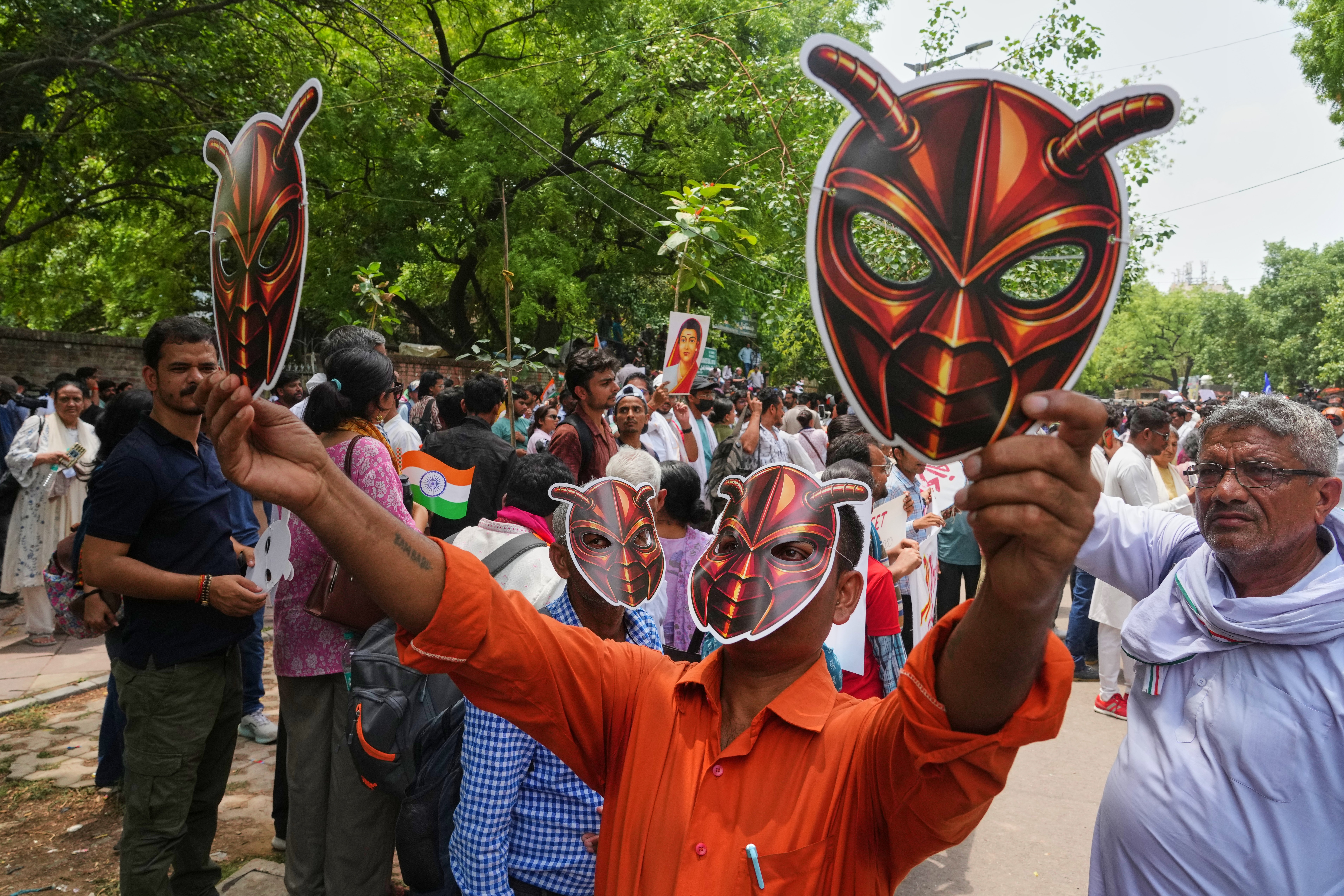 Protesters wearing cockroach masks near India's parliament during the rally against exam system failures