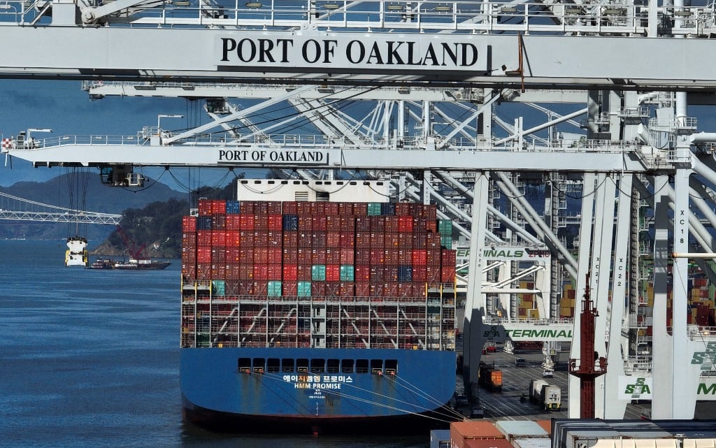A shipping crane positioned over a container ship at the Port of Oakland in California