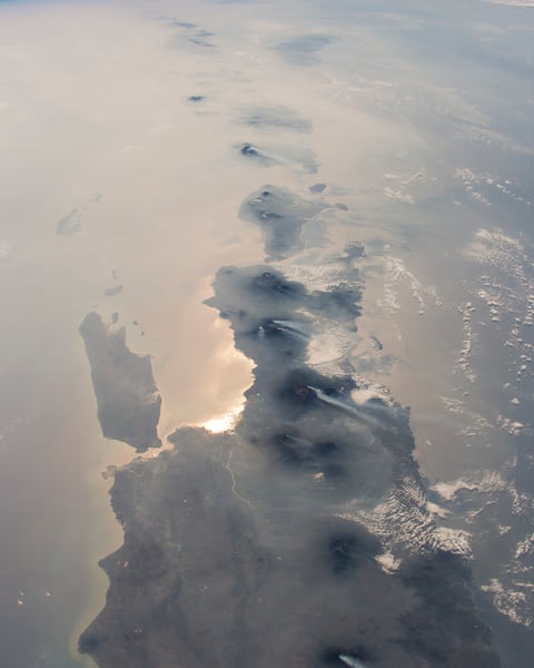 NASA astronaut photograph from the International Space Station showing nearly half the length of Indonesia's main island chain with Java Bali Lombok Sumba and Timor visible against the Indian Ocean