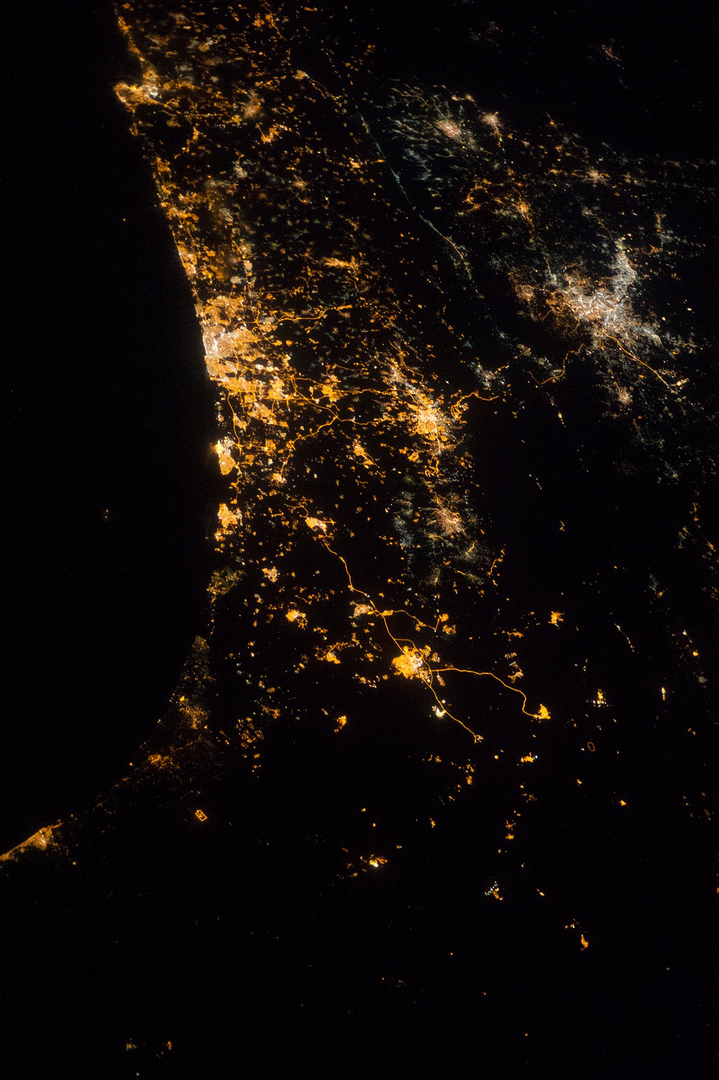 NASA astronaut nighttime photograph from the International Space Station of the Eastern Mediterranean coastline showing Tel Aviv as the brightest cluster Jerusalem and Amman as additional bright clusters with highways snaking between them