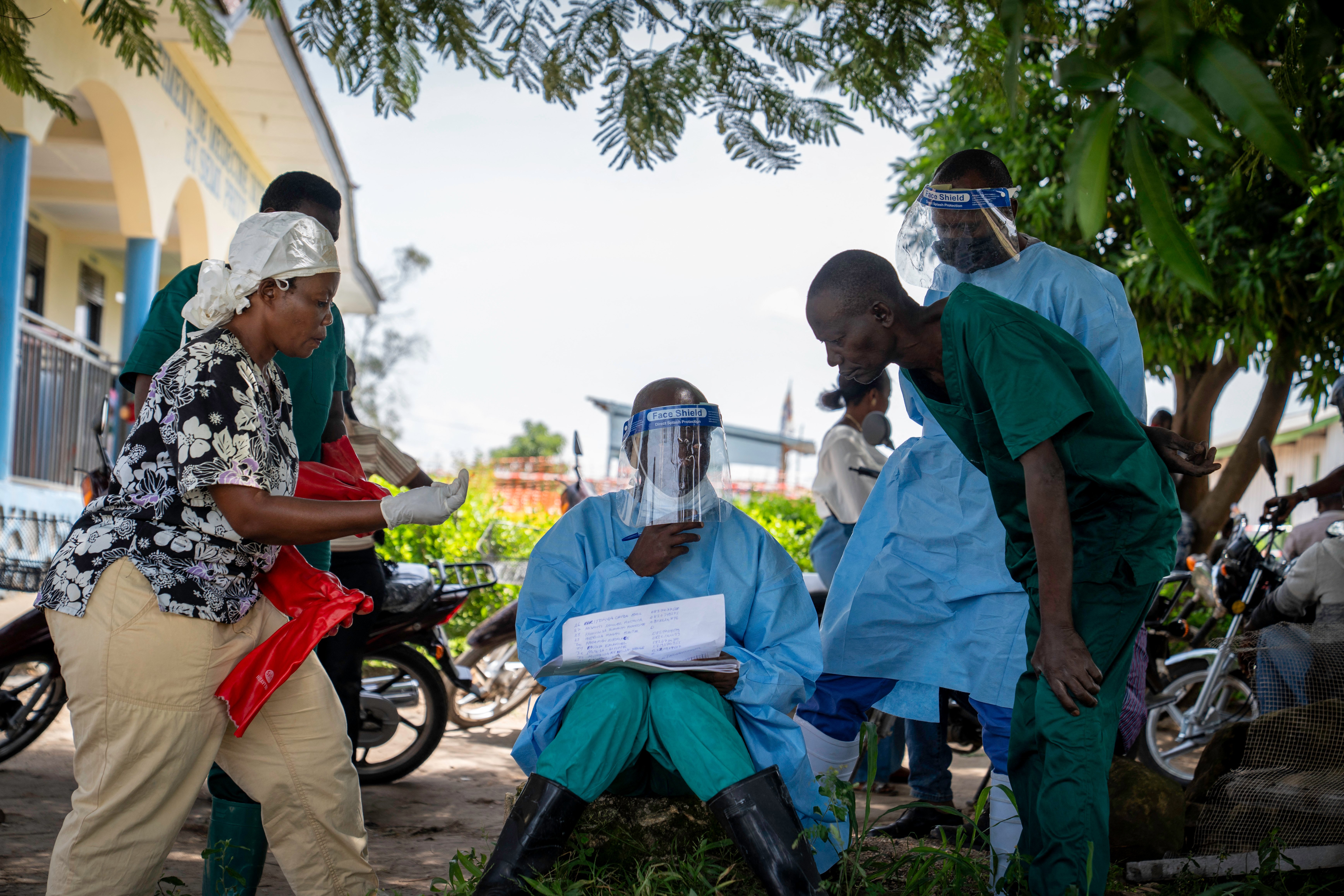 Health worker reviewing patient list at Rwampara Hospital in Ituri province, DRC, during Ebola outbreak