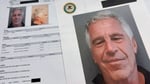 DOJ-released Epstein files documents photographed on a desk
