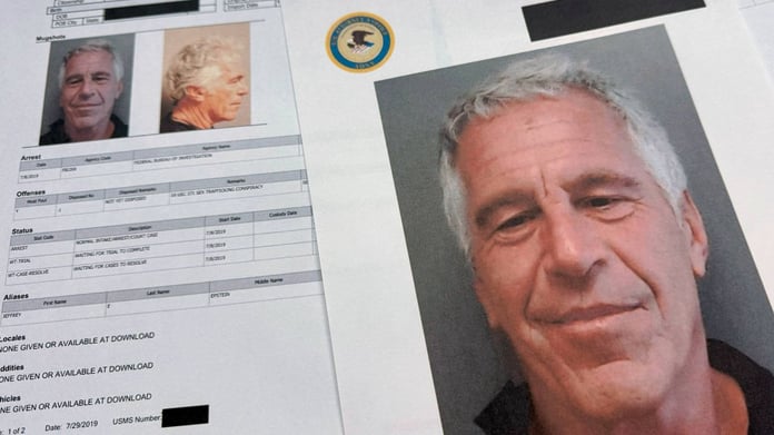 DOJ-released Epstein files documents photographed on a desk