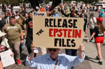 Protester holds sign saying Release the Epstein Files at a demonstration in Washington DC