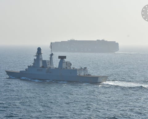 EUNAVFOR warship escorts a container ship through the Red Sea as part of EU Operation ASPIDES
