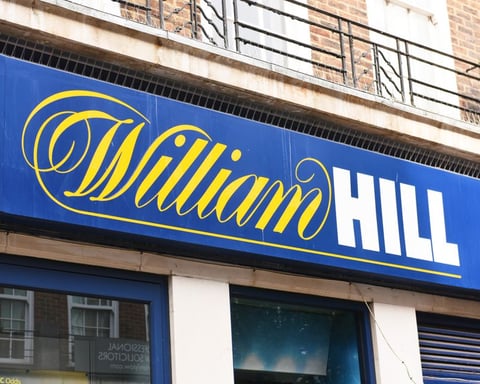 William Hill betting shop exterior Britain Evoke Bally's Intralot takeover 2026