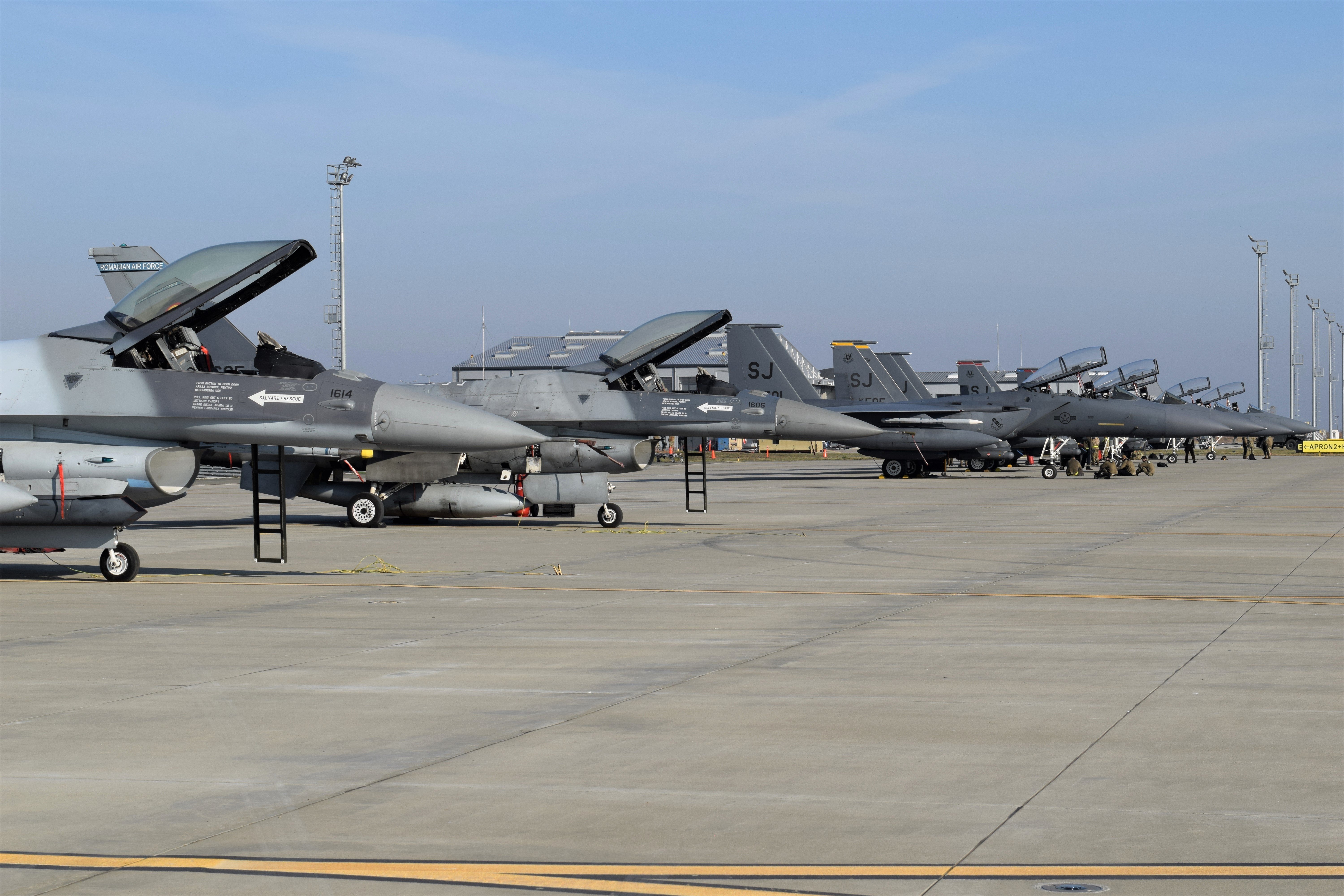 US Air Force F-15E Strike Eagles and F-16 fighter jets in flight, the aircraft being cut from NATO's European posture