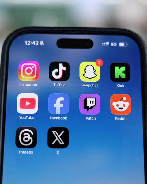 A child looks at a smartphone in the dark as France moves to ban social media for under-15s