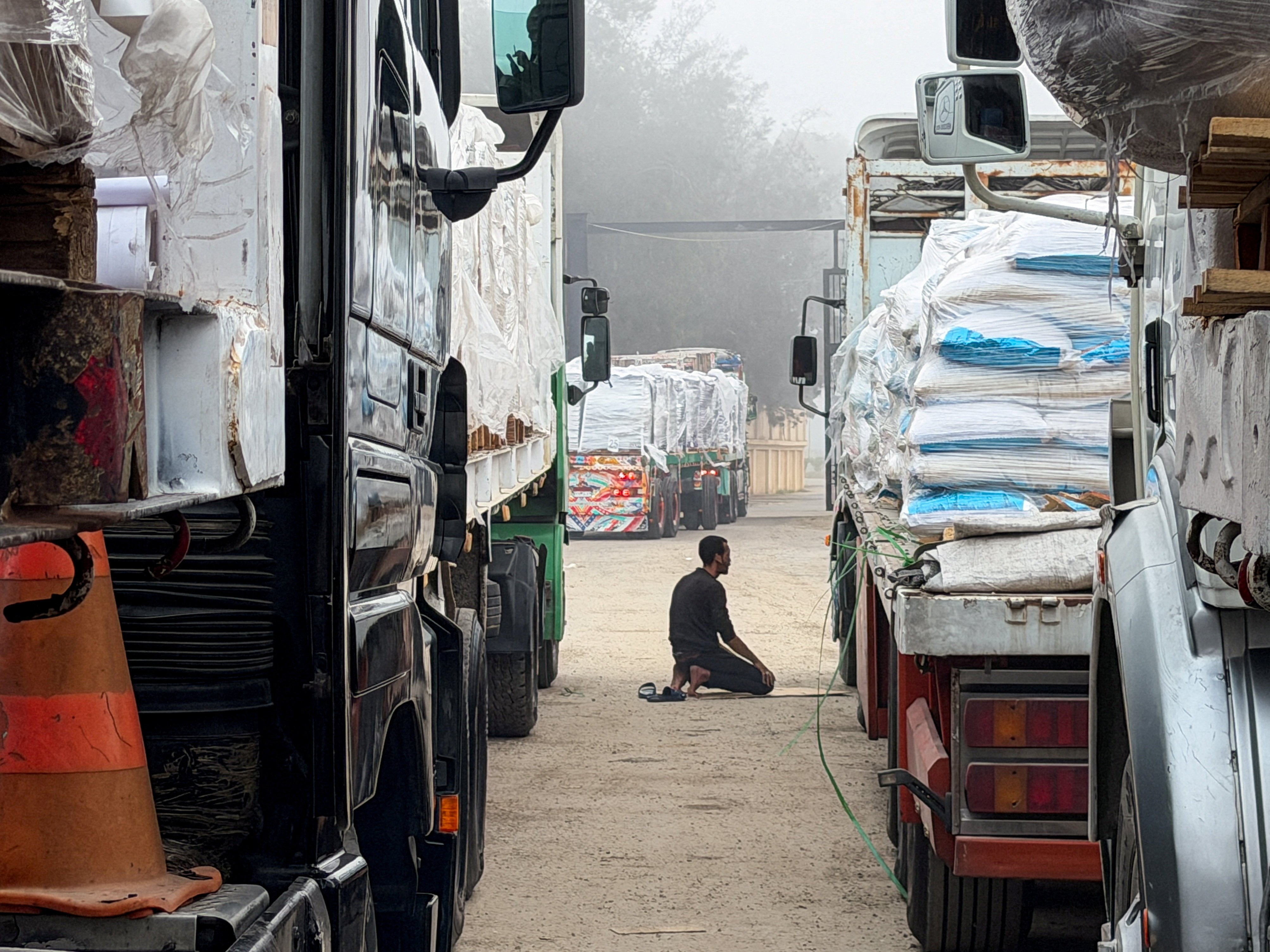Trucks carrying humanitarian aid lined up at the Rafah border crossing into Gaza