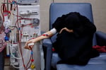 A Palestinian woman with kidney failure undergoes dialysis in Gaza while hoping to leave for treatment abroad
