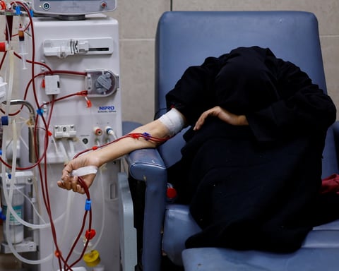 A Palestinian woman with kidney failure undergoes dialysis in Gaza while hoping to leave for treatment abroad