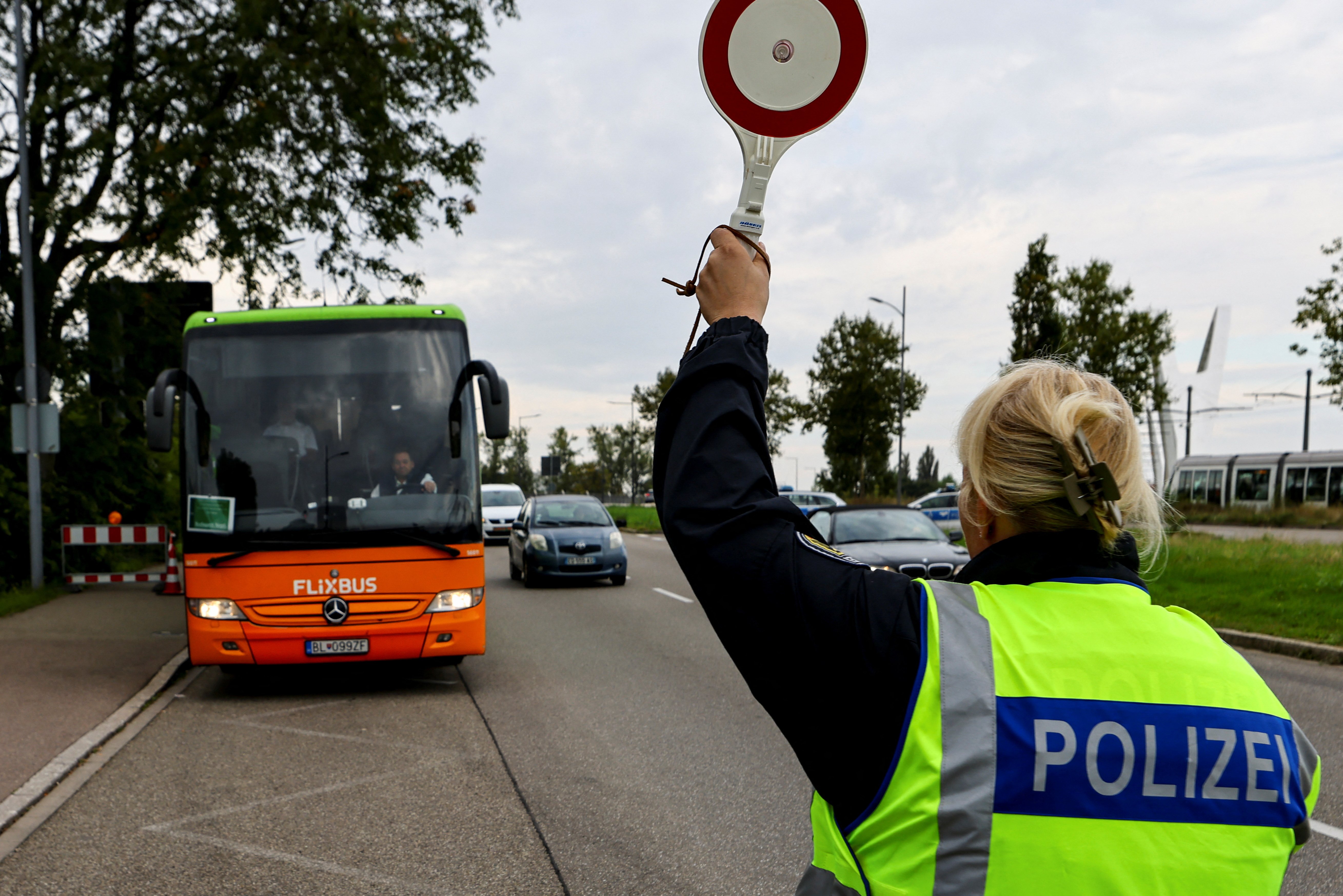 German federal police officer conducting spot checks at a land border crossing under Germany's expanded Schengen internal border controls