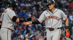 Jung Hoo Lee gets a high-five from Luis Arraez after his RBI single in the first inning against the Cubs at Wrigley Field
