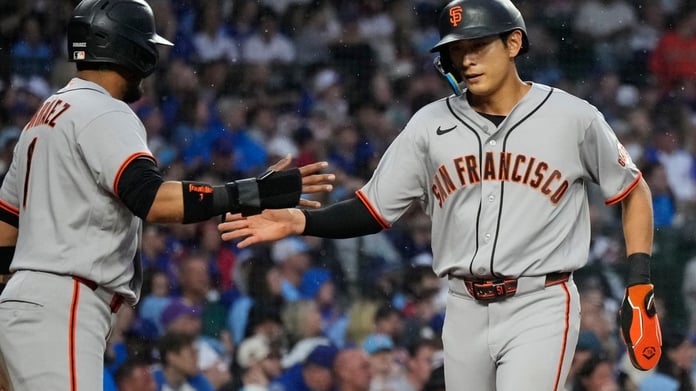 Jung Hoo Lee gets a high-five from Luis Arraez after his RBI single in the first inning against the Cubs at Wrigley Field