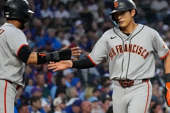 Jung Hoo Lee gets a high-five from Luis Arraez after his RBI single in the first inning against the Cubs at Wrigley Field