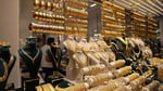 Gold bars and bullion representing the spot gold market as prices fall below the 200-day moving average in June 2026
