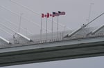 Canadian and US flags fly on the Gordie Howe International Bridge connecting Windsor, Ontario and Detroit