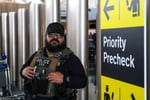 A federal immigration agent patrols John F Kennedy International Airport in New York