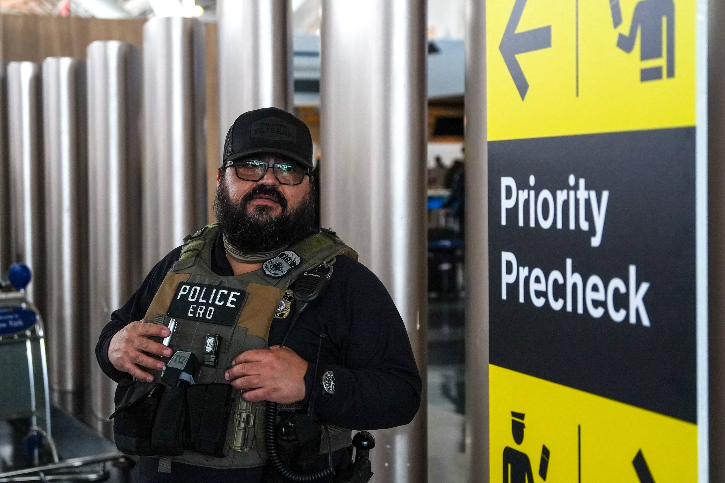A federal immigration agent patrols John F Kennedy International Airport in New York
