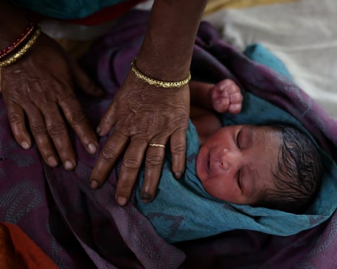 A nurse cares for a newborn baby at a hospital in Kishanganj district of Bihar, the Indian state with the highest fertility rate