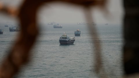 A commercial tanker burns in the Strait of Hormuz after US Navy strikes; three Indian sailors were among the dead