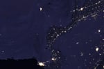 NASA VIIRS satellite image showing the Indus River basin in Pakistan at night with the sinuous shape of the river outlined by the lights of cities Lahore Multan Sukkur and Karachi against the darker desert and mountain landscape