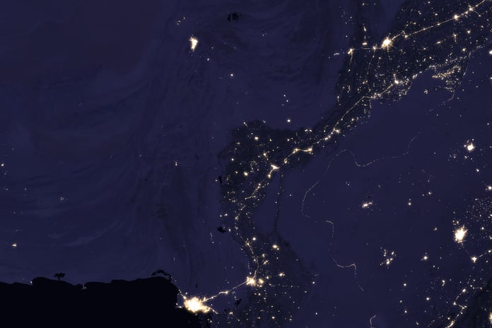 NASA VIIRS satellite image showing the Indus River basin in Pakistan at night with the sinuous shape of the river outlined by the lights of cities Lahore Multan Sukkur and Karachi against the darker desert and mountain landscape