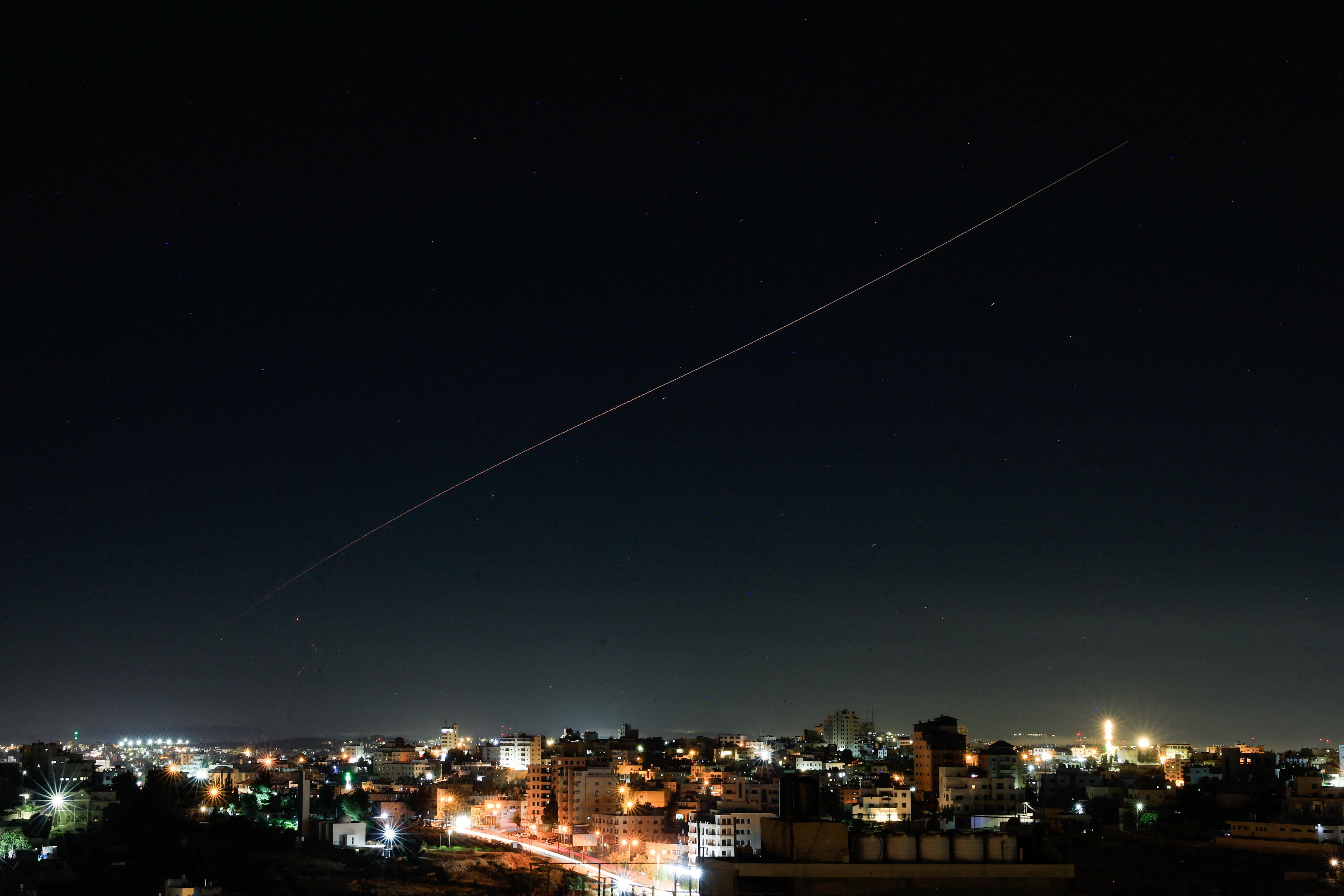 An Iranian missile flies in the sky over Israel as US Embassy orders staff to shelter in place June 2026