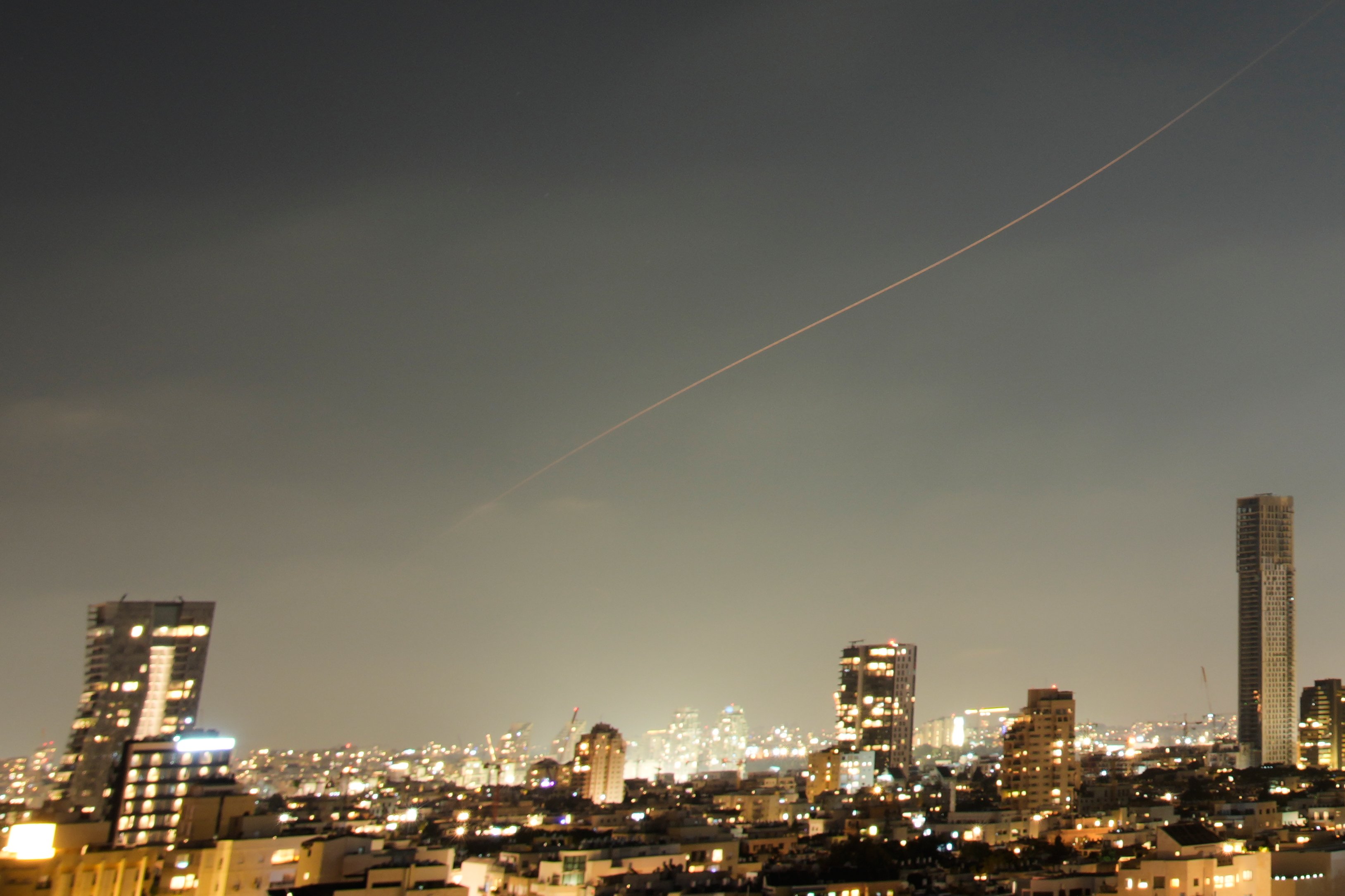 Projectile from Iranian missile attack streaks over central Israel June 7 2026