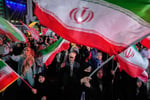 Demonstrators wave Iranian flags at a pro-government rally in Tehran
