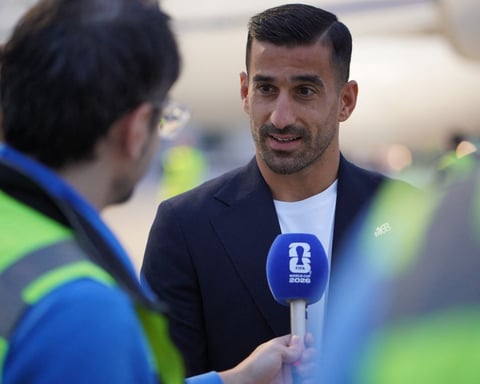 Iran captain Ehsan Hajsafi speaks to reporters as the national team arrives for the 2026 World Cup