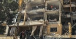 First responders inspect damage at apartment building hit by Israeli airstrike in Beirut Dahiyeh suburb June 2026
